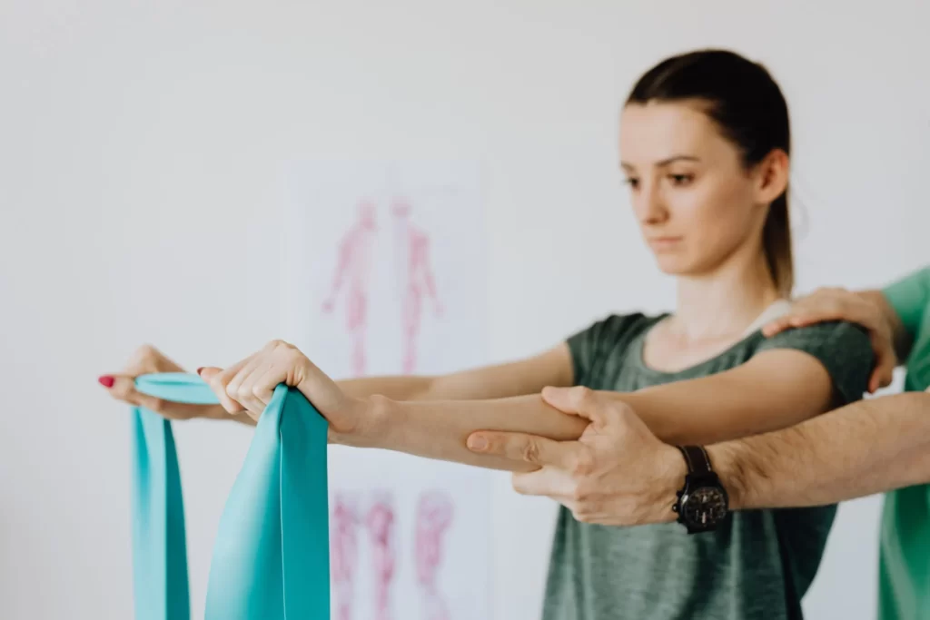 Image of woman using resistance band for chiropractic care.
