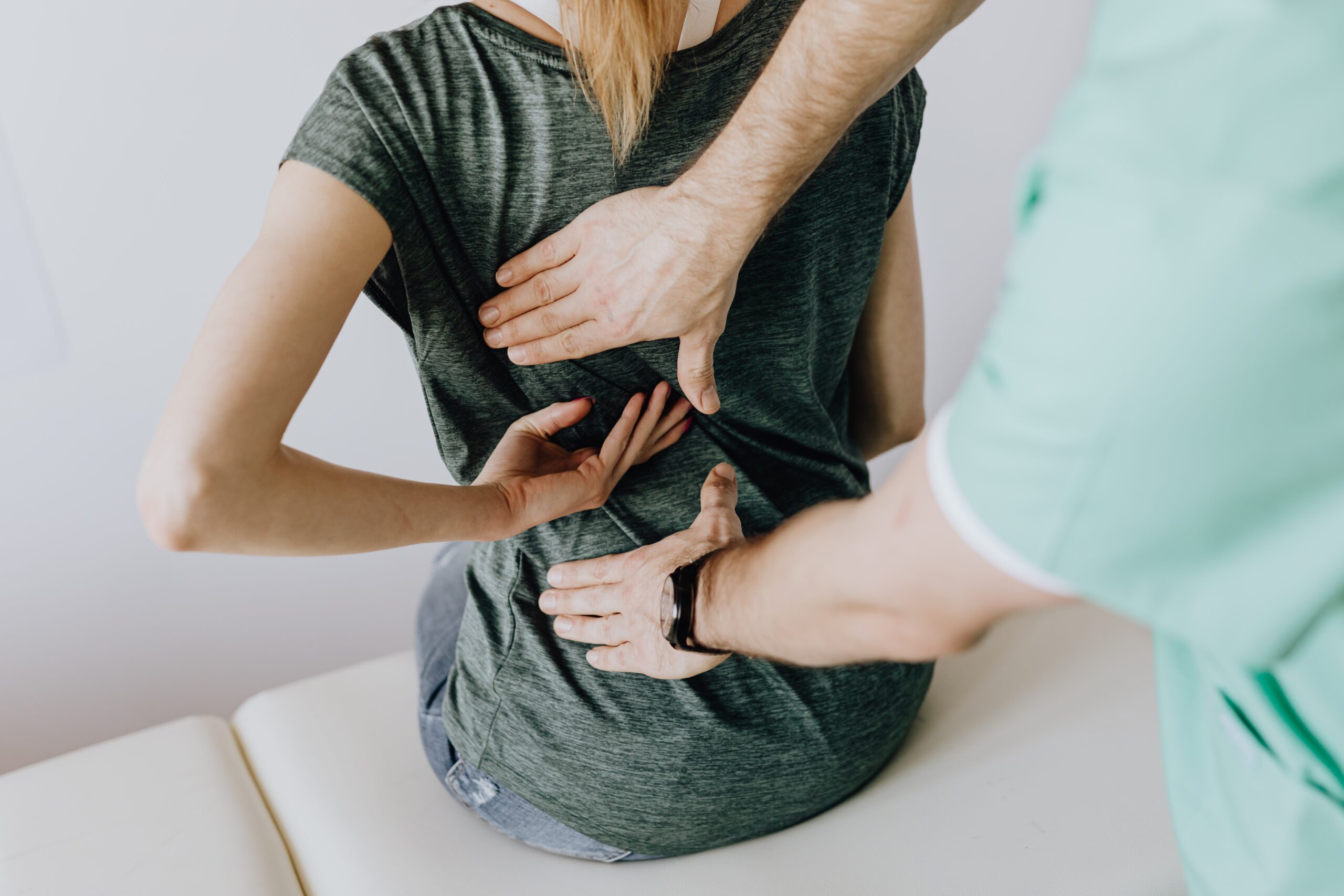 An image of a woman receiving chiropractic treatment on her back